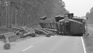 Driver injured when log truck overturns on way to mill