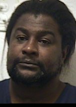 Man charged with shooting into residence
